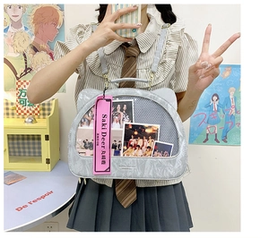 Detail of grey cat-ear backpack with transparent DIY display window and metal buckles