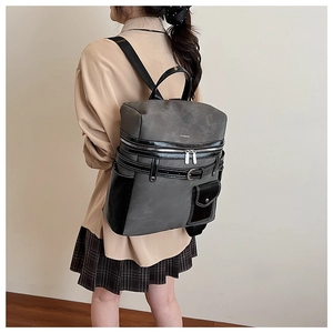 Detailed side view of a grey and black contrast backpack with stylish buckle straps