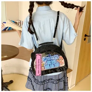 Detail view of the black patent leather cat-ear ita bag with a clear display window