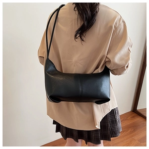 Minimalist black faux leather underarm bag shown with casual autumn outfit styling