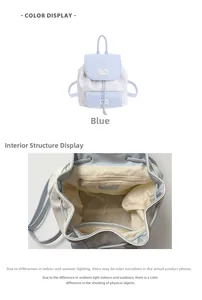 Detail view of the blue school backpack showing the interior lining and cat embroidery