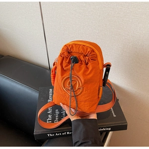 Detail of orange nylon crossbody phone bag with drawstring and embroidered D logo