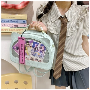 Detail of blue cat ear ita bag featuring a transparent window for anime cards