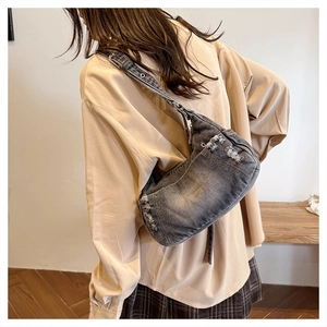 Detail of vintage washed denim tote bag featuring distressed edges and frayed accents