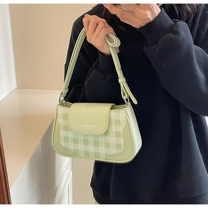 Détail du motif damier vert clair sur un sac à bandoulière rétro en similicuir