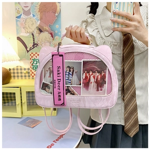 Detail of pink cat-ear backpack with transparent PVC window displaying celebrity photos