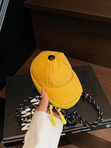 Mini yellow baseball cap shaped crossbody bag with checkered texture and woven strap