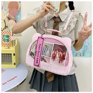 Detailed view of a pink cat-eared ita bag with transparent window and leather strap