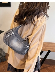 Vintage gray denim shoulder bag with distressed details and retro washed finish
