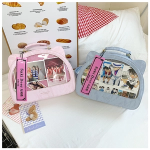 Detail view of cat-ear ita-bags with transparent PVC windows in pink and blue colors