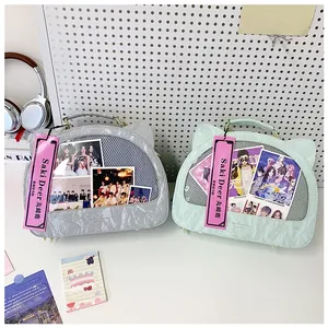 Detail of transparent PVC cat-ear display windows on textured gray and mint backpacks
