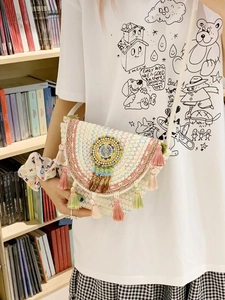 Bohemian hand-woven straw bucket bag with colorful fringe tassels and dreamcatcher detail