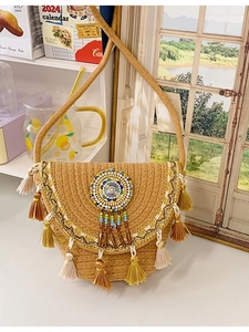 Bohemian hand-woven straw bucket bag with ethnic embroidery and colorful tassel charms