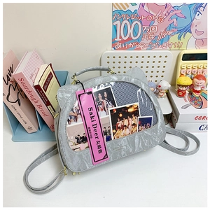 Close-up of cat-eared gray backpack with clear window for displaying small items
