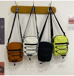 Detail of multi-color nylon crossbody bags with adjustable straps and zippered pockets