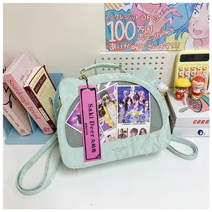 Detail of mint green cat-ear bag with transparent window for anime collectibles