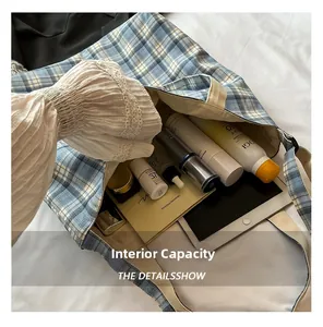 Spacious interior of a checkered canvas tote bag holding a tablet and cosmetics
