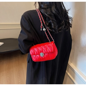 Red quilted leather crossbody bag with silver chain strap and metal twist lock
