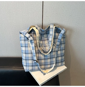 Close-up of blue plaid canvas tote bag with FOR YOU embroidery and adjustable strap
