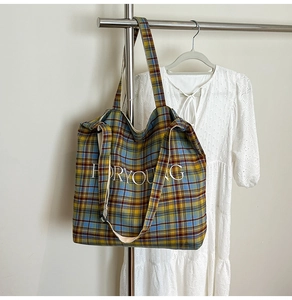 Close-up of classic plaid tote bag with FORYOUNG embroidery on high-quality canvas fabric