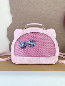 Pink cat-ear ita bag with a large mesh window and marble textured synthetic leather