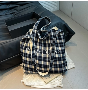Detailed view of the blue and white checkered tote bag with FORYOUNG embroidery