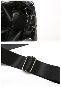 Detail of adjustable nylon strap and metal swivel hook on black quilted travel bag