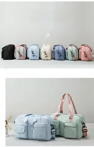 Detailed close-up of colorful waterproof travel bags with dual handles and shoulder straps