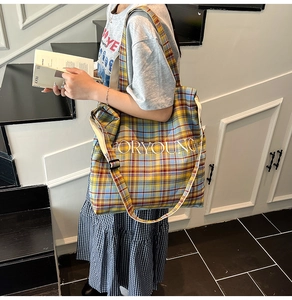 Detailed view of large plaid tote bag featuring FOR YOUNG print and adjustable strap