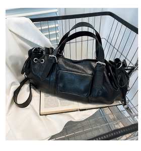 Detailed view of black lychee grain texture with silver hardware and drawstring on bag