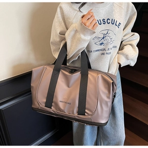 Detail of expandable dusty pink travel bag with metallic finish and bottom shoe compartment
