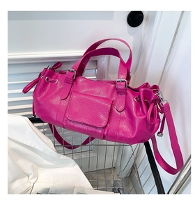 Detail of magenta lychee grain leather bag with silver hardware and drawstring side