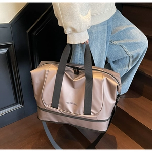 Detail of expandable travel bag featuring waterproof fabric and bottom shoe compartment