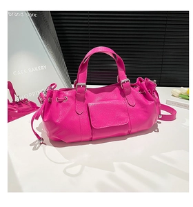 Detail showing the glossy rose pink ruched texture and side drawstring on this chic handbag