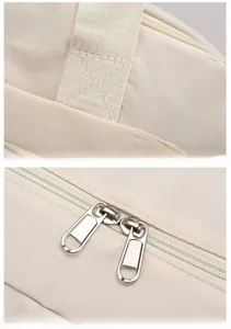Macro detail of twill fabric texture and reinforced stitching on beige travel bag