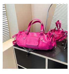 Macro shot of fuchsia textured leather handbag with silver metallic buckle detail
