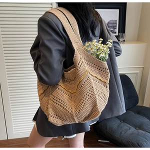 Detail of hand-woven tote bag showing yellow wavy stitching and khaki crochet texture