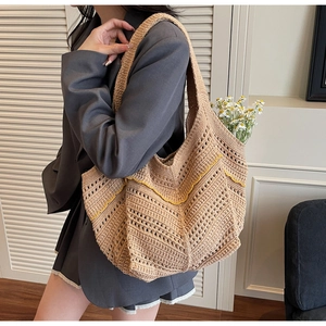 Detail of hand-woven tote bag with yellow wavy pattern and wide shoulder strap