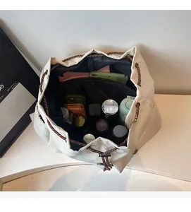 Top view of white drawstring backpack showing spacious interior with personal essentials