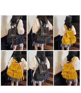 Detail of solid color waterproof backpack featuring brand embroidery and drawstring side pockets