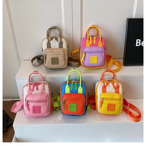 Close-up of colorful mini canvas backpacks in multiple vibrant color variants
