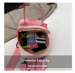 Detailed interior of a pink mini backpack showing pockets for phone, power bank and makeup