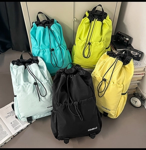 Detailed view of water-resistant nylon drawstring backpacks in five vibrant colors