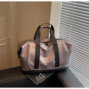 Close-up of waterproof champagne purple travel bag on sofa with double zipper and strap