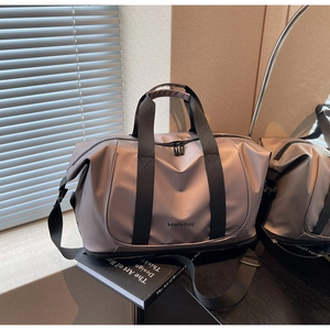 Close-up of waterproof nylon travel bag with reinforced handles and separate shoe compartment