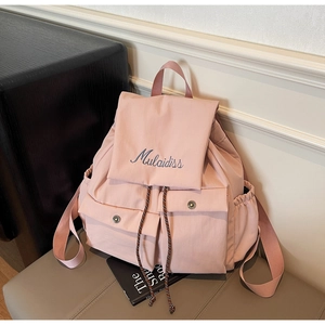 Close-up of pink nylon backpack featuring branded embroidery and textured drawstring