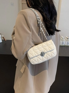 Elegant white quilted crossbody bag with silver chain strap and metal ball charms