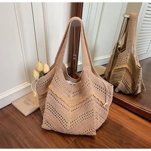 Detail of crochet tote bag with V-shaped weave and yellow wavy trim with drawstring