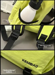 Detail view of green nylon backpack showing side pocket, adjustable strap and embroidery