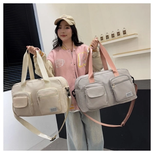 Detail of multi-functional travel bags in cream and grey with adjustable straps